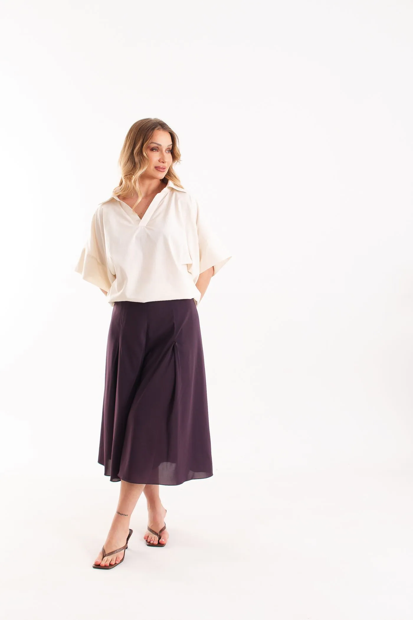 Polo Nácar off-white de gola polo, com saia midi roxa de pregas